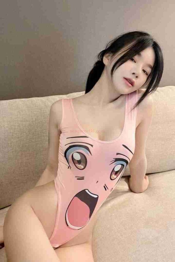 Asian woman in anime face swimsuit sitting on couch. Ming Yue Chinese Call Girl.