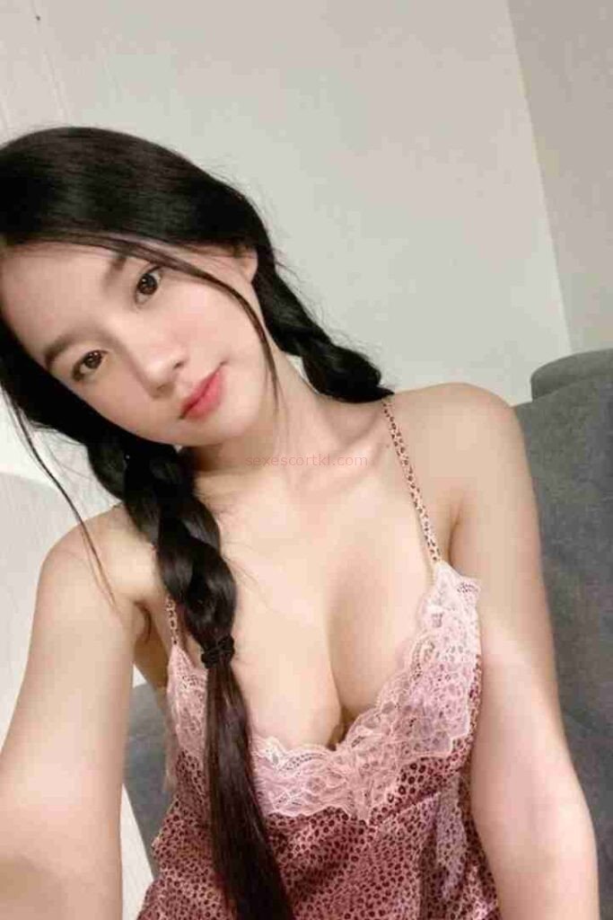 Attractive Asian woman with braids in pink lace top. Ming Yue Chinese Call Girl.