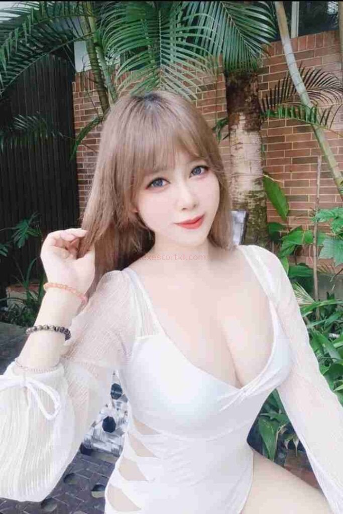 Attractive woman with blonde hair in white dress. Lienna Escort Girl.