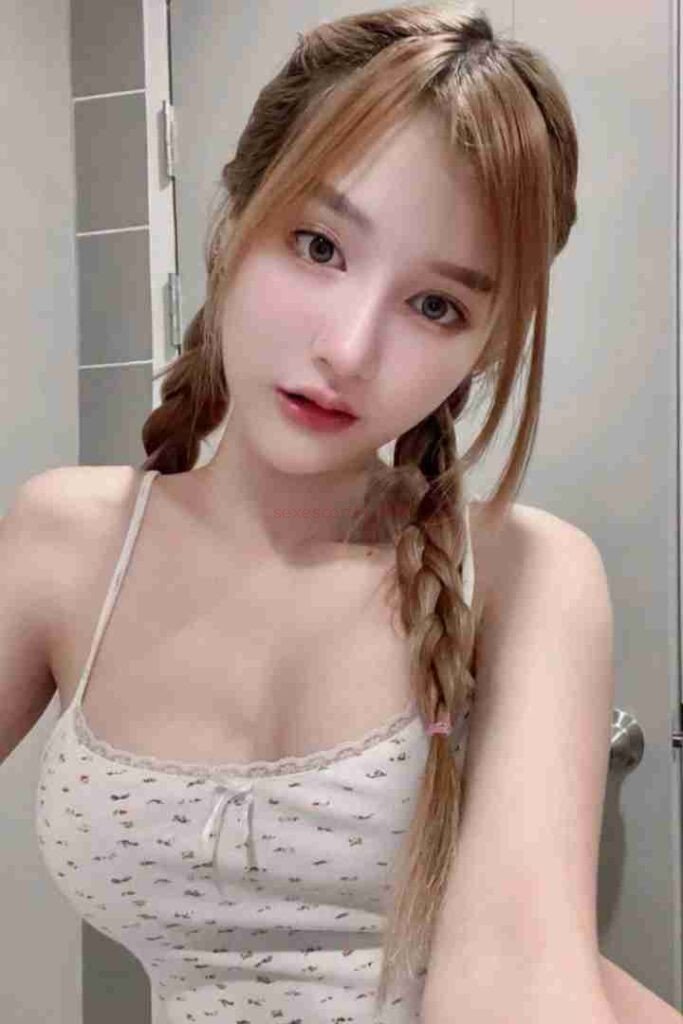 Kannika Thai Escort with braids and floral top.