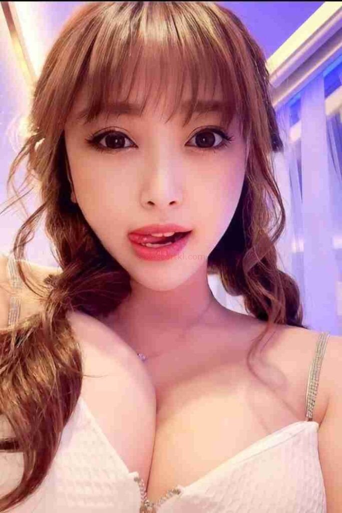Attractive Asian woman with pigtails and open mouth, suggestive expression. Li Jing Chinese Escort.
