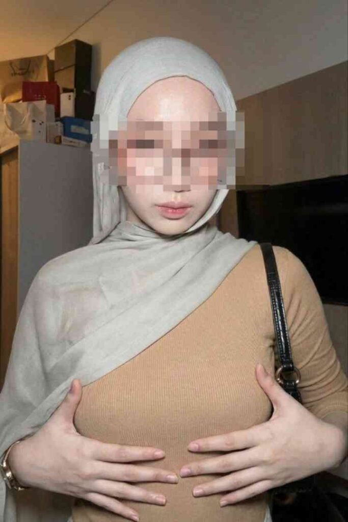 Sex Escort KL Girl Malay call girl posing with hands on chest in a room Incall & Outcall Escorts Girl Service